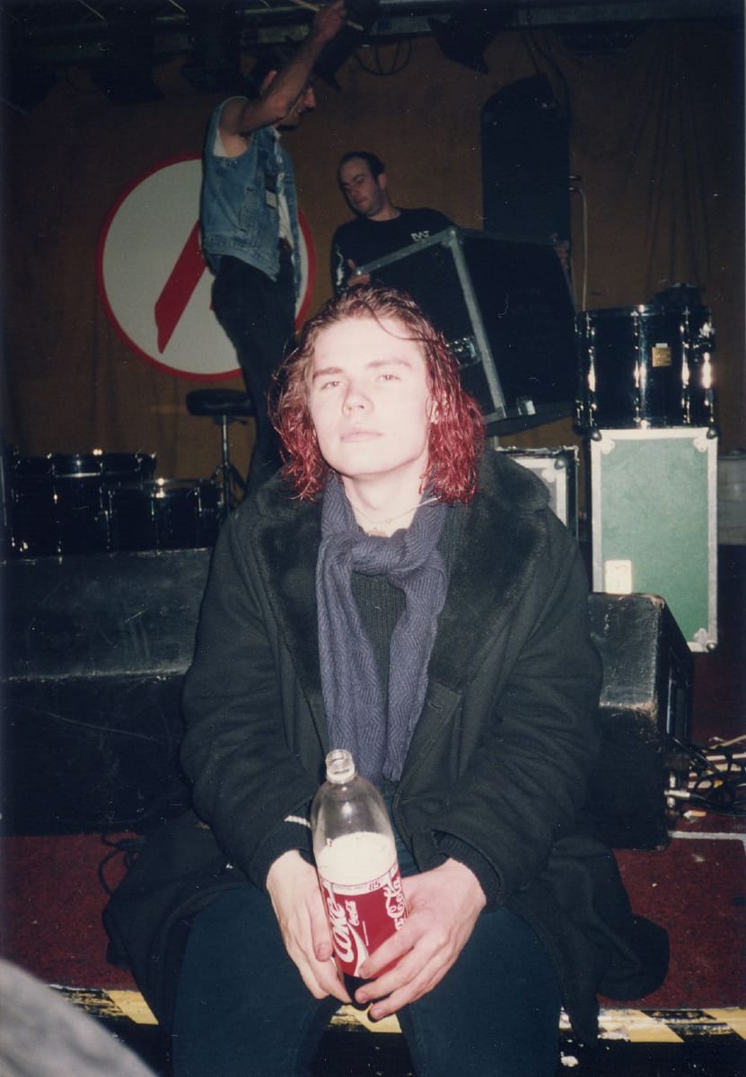 Billy Corgan in 1992, with red hair and a dark coat