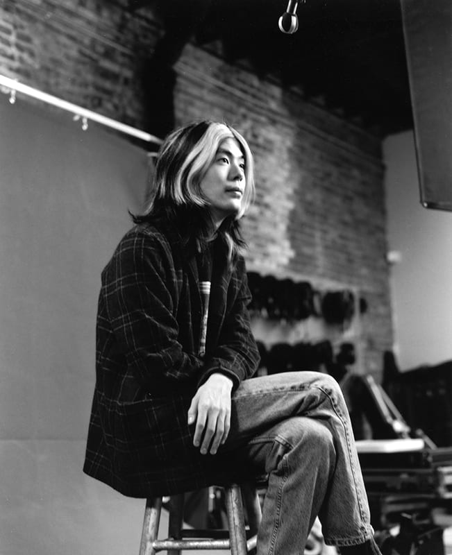 James Iha in 1995, seated, in black and white