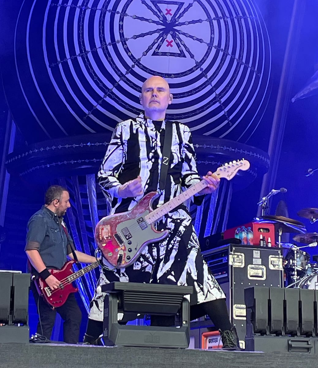 Billy Corgan on stage in 2025 in a patterned coat